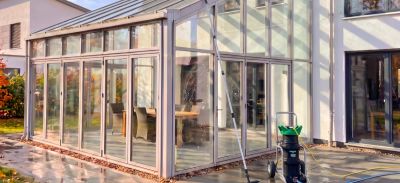 Wintergarten eines modernen Hauses das gerade mit Osmose Geräte gereinigt wird.